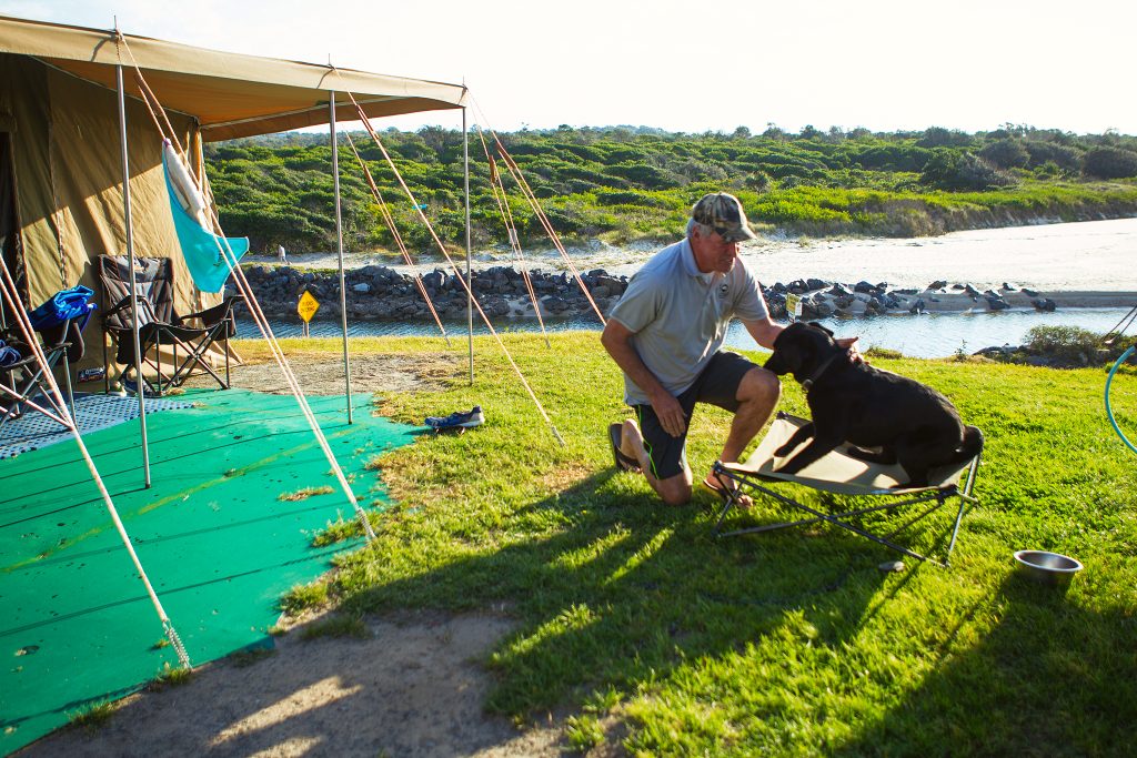 A guest camping with his dog at Macleay Valley Coast Holiday Parks