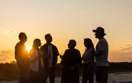 Group chatting at sunset